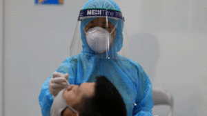 Khử khuẩn găng tay y tế, đảm bảo giãn cách giúp ngăn lây nhiễm chéo khi lấy mẫu xét nghiệm Covid-19 /// ẢNH ĐẬU TIẾN ĐẠT